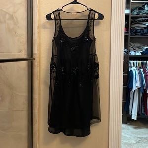Black silky dress with a sheer dress over it